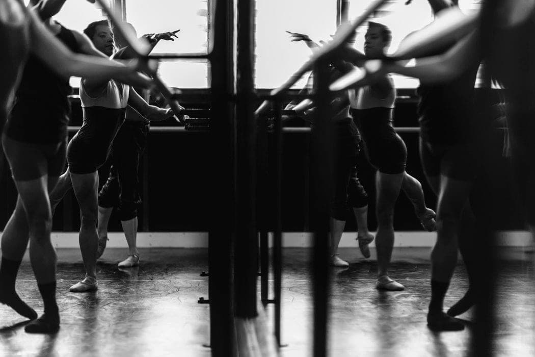 Dancers working at the barre in a class