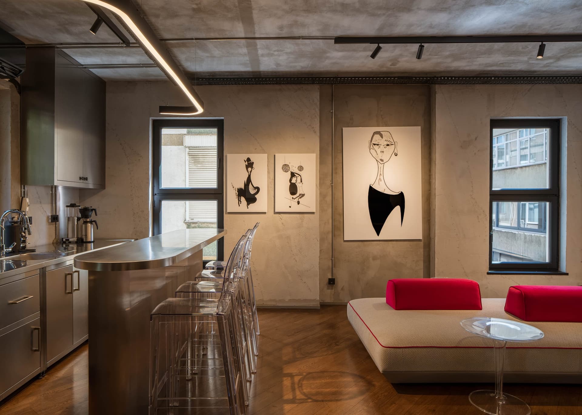 Lounge area with a kitchen bar and a beige sofa with red cushions